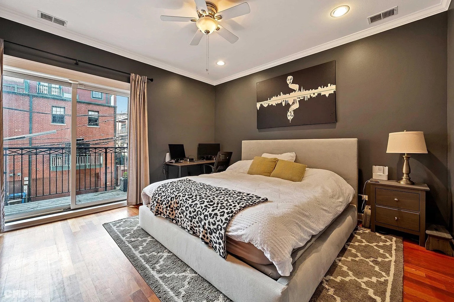 1035 West Madison Street, Unit 2 Chicago, IL 60607 - Photo 9 of 17 a bedroom with a large bed and a chandelier