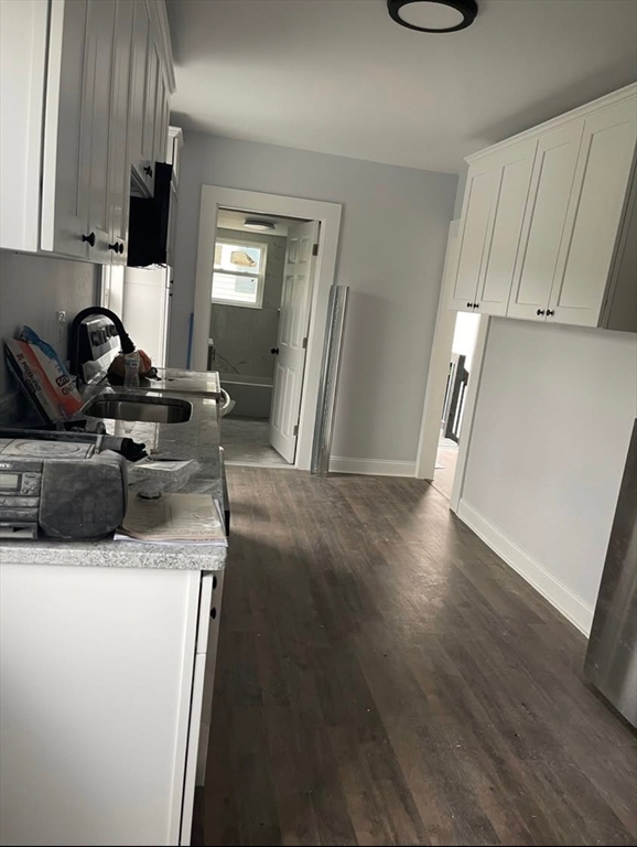 43 Maple Street, Unit 2 Spencer, MA 01562 - Photo 2 of 4 a view of a kitchen with fridge and wooden floor