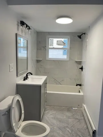 a bathroom with a sink toilet and bathtub
