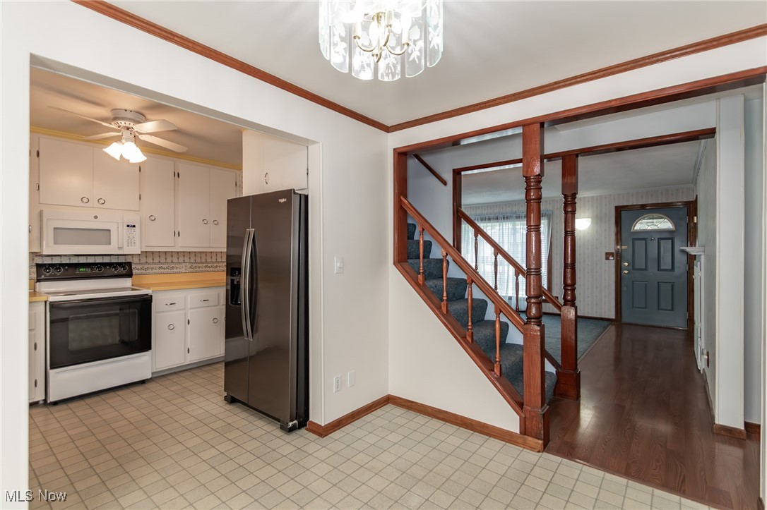 5223 Edenhurst Road Cleveland, OH 44124 - Photo 20 of 50 Kitchen featuring white appliances, light countertops, a chandelier, white cabinets, and a ceiling fan