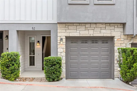 front view of a house with a potted plant and garage