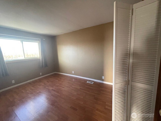 64 Lakeview Way Brewster, WA 98812 - Photo 14 of 31 a view of an empty room with wooden floor and a window