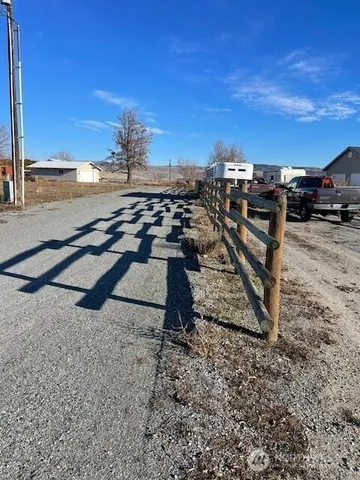 a backyard of a house with lots of green space and fountain