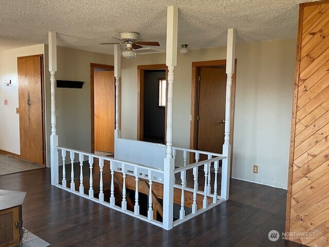 64 Lakeview Way Brewster, WA 98812 - Photo 7 of 31 a view of a hallway with wooden floor and windows