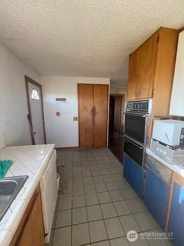 a kitchen with a sink appliances and cabinets