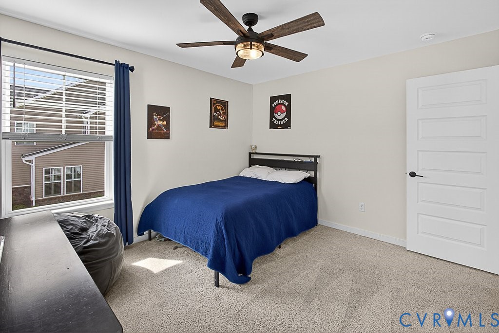 18517 Palisades Ridge Moseley, VA 23120 - Photo 29 of 55 a bedroom with a bed and a chandelier
