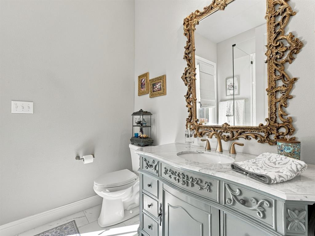 330 Rolling Bnd Road Alvord, TX 76225 - Photo 30 of 36 Vanity with ornate trim, marble countertop, and integrated sink right off the back patio.
