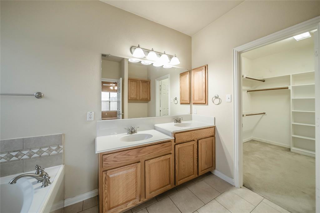 1117 Baylor Road Melissa, TX 75454 - Photo 25 of 40 a spacious bathroom with a granite countertop sink a toilet a mirror and shower