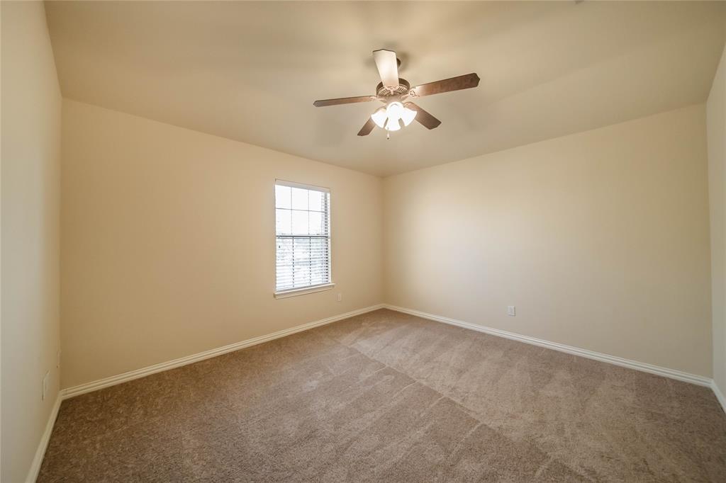 1117 Baylor Road Melissa, TX 75454 - Photo 29 of 40 a view of an empty room with chandelier fan and a window