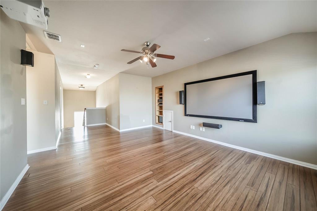1117 Baylor Road Melissa, TX 75454 - Photo 32 of 40 a view of a room with wooden floor and ceiling fan
