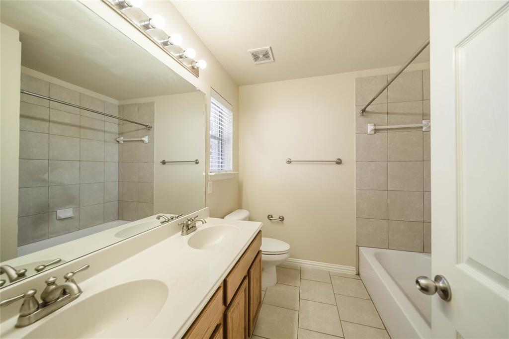 1117 Baylor Road Melissa, TX 75454 - Photo 35 of 40 a bathroom with a granite countertop sink a shower and a mirror