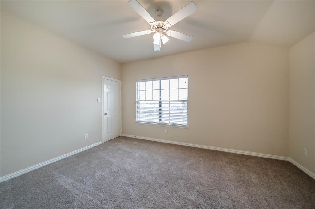 1117 Baylor Road Melissa, TX 75454 - Photo 36 of 40 an empty room with a chandelier fan and windows