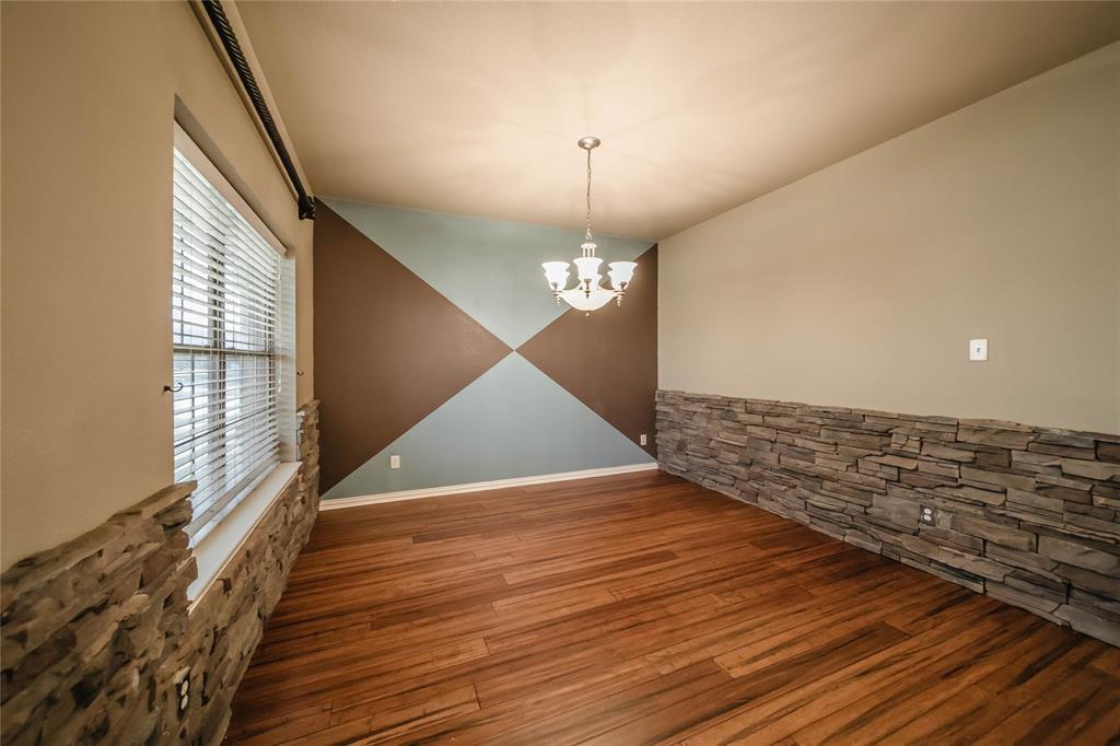 1117 Baylor Road Melissa, TX 75454 - Photo 5 of 40 a view of an empty room with wooden floor and a window