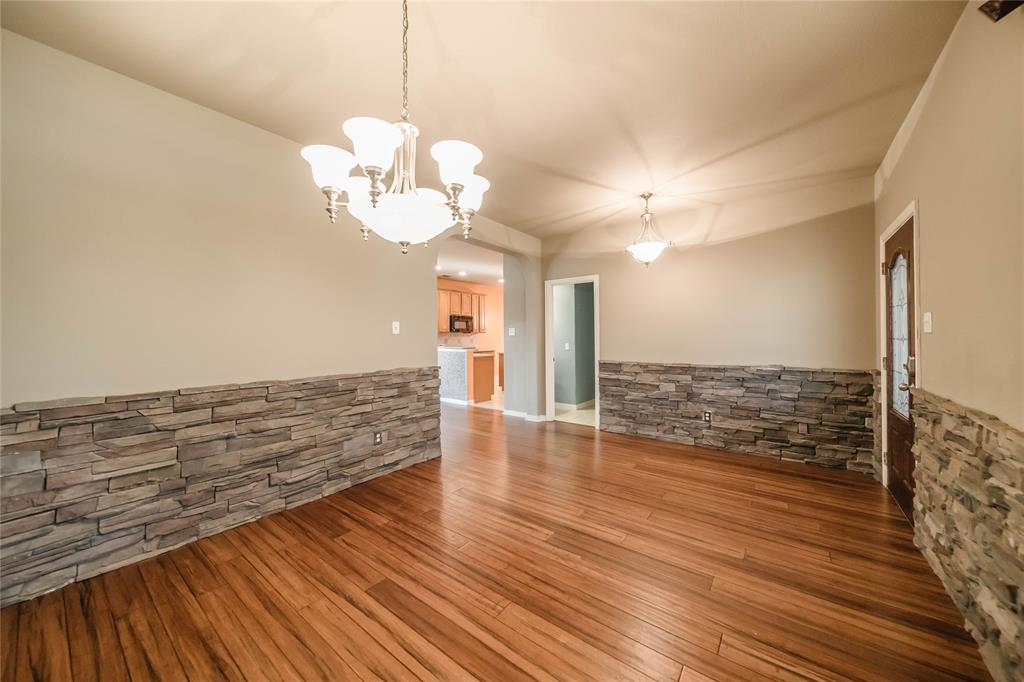 1117 Baylor Road Melissa, TX 75454 - Photo 7 of 40 a view of a room with wooden floor and chandelier
