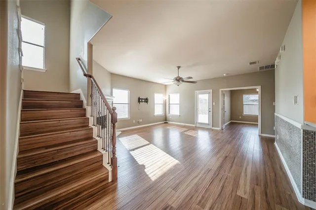 a view of entryway and hall with wooden floor