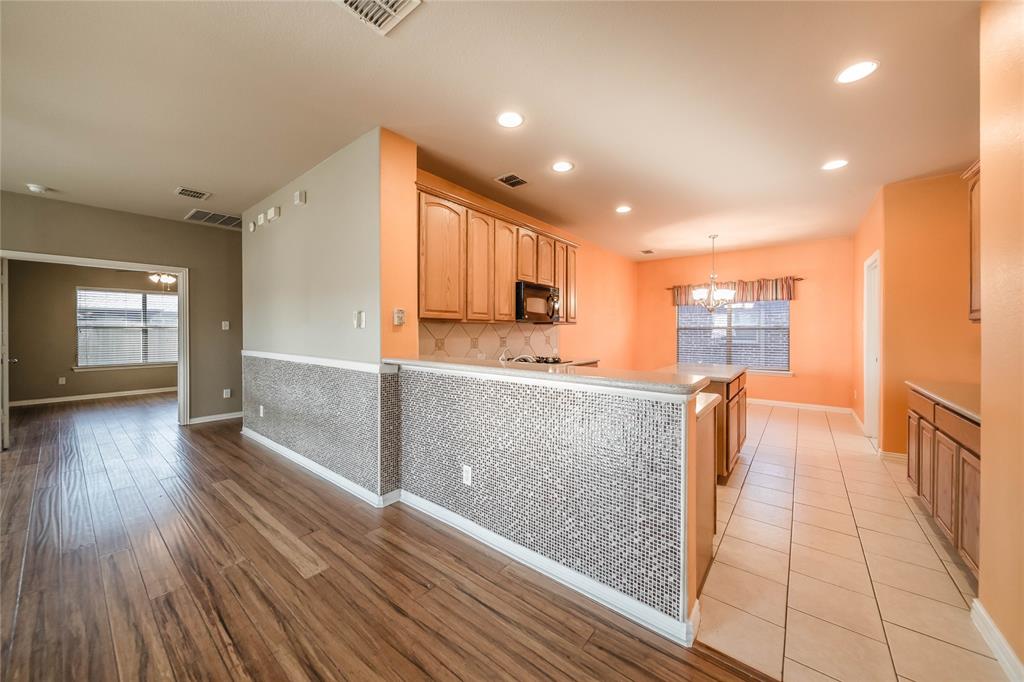 1117 Baylor Road Melissa, TX 75454 - Photo 10 of 40 a view of kitchen with cabinets and wooden floor