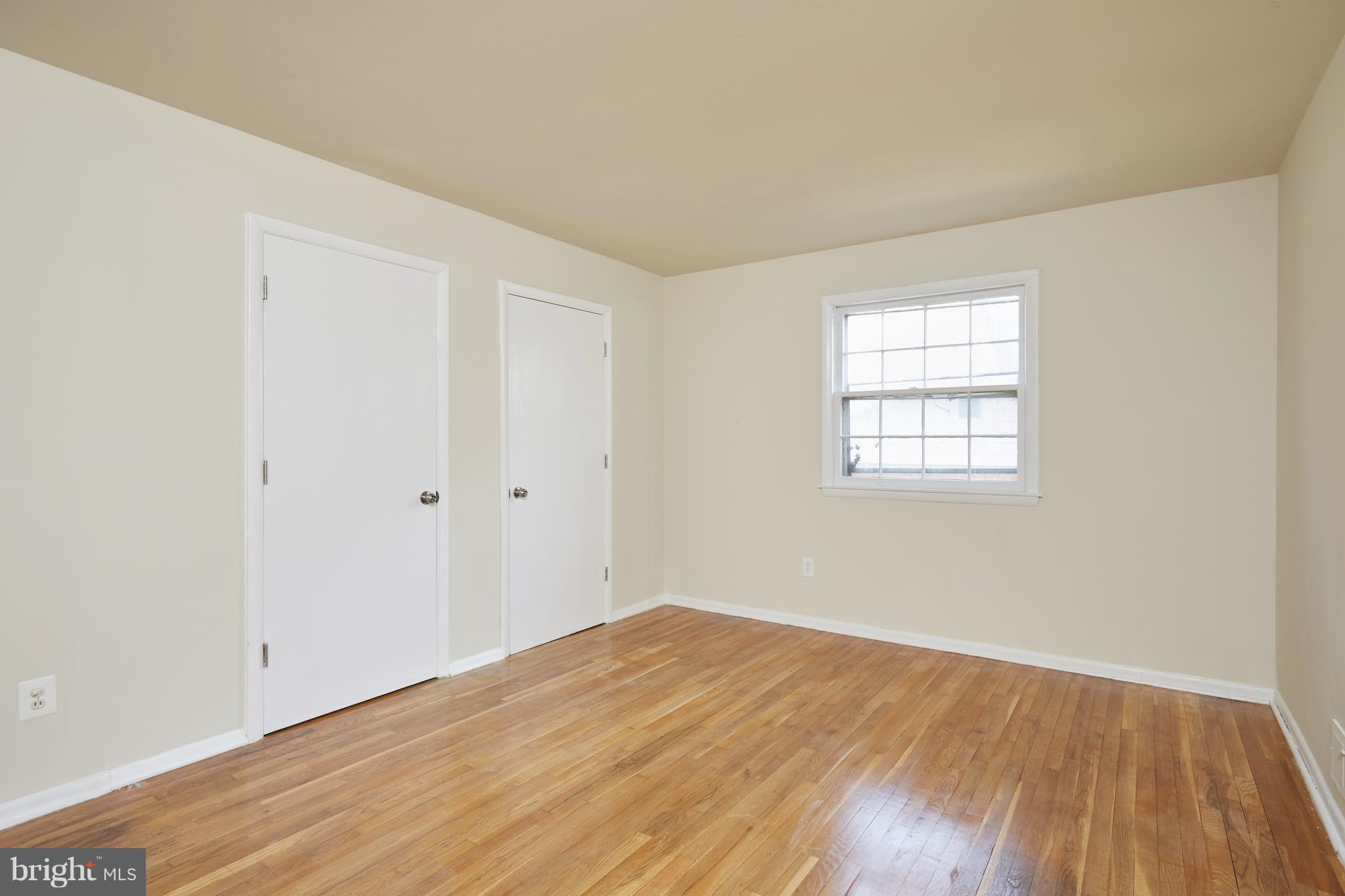 12901 Layhill Road Silver Spring, MD 20906 - Photo 14 of 30 an empty room with wooden floor and windows