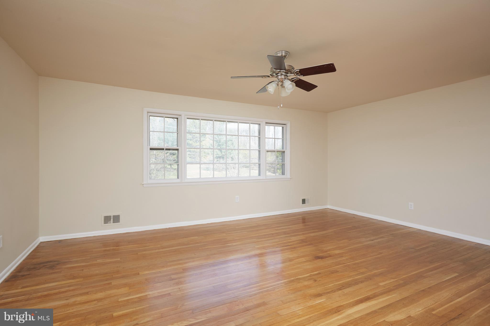 12901 Layhill Road Silver Spring, MD 20906 - Photo 3 of 30 a view of empty room with wooden floor and fan