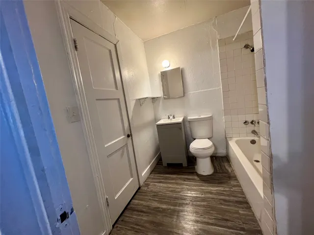a bathroom with a toilet sink and a mirror