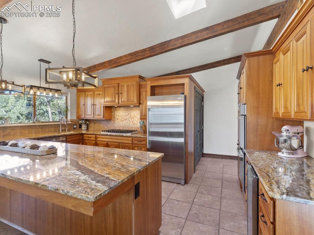 10530 Hungate Road Colorado Springs, CO 80908 - Photo 12 of 42 a kitchen with kitchen island granite countertop a sink and counter space