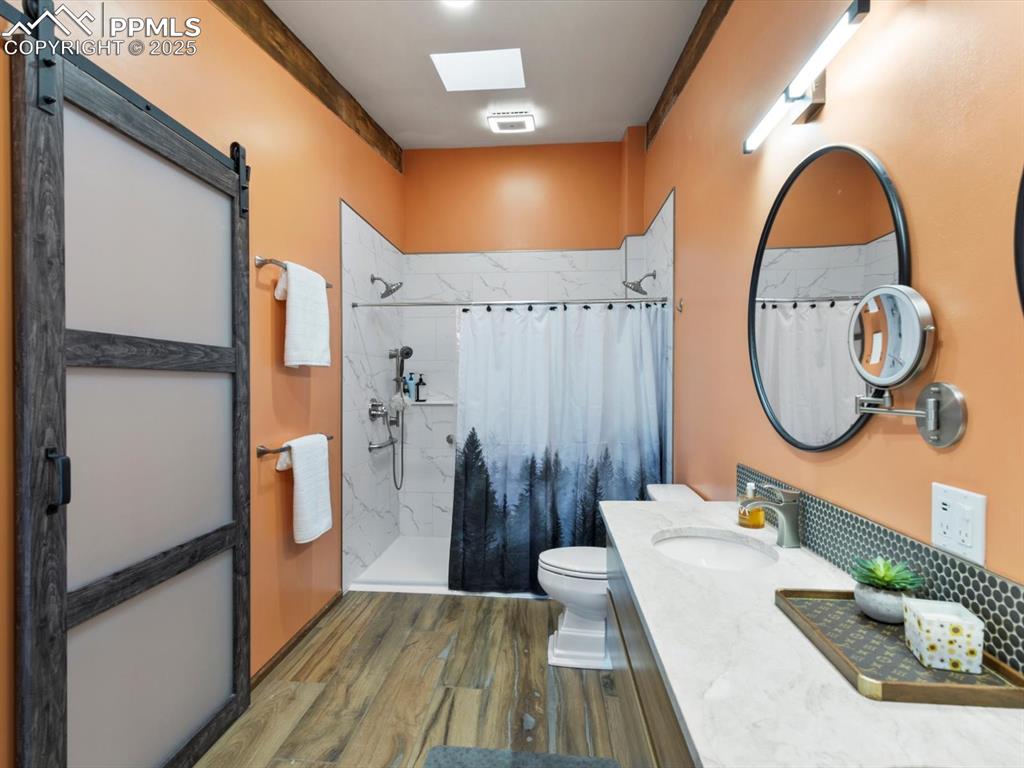 10530 Hungate Road Colorado Springs, CO 80908 - Photo 18 of 42 a bathroom with a sink a mirror and a shower