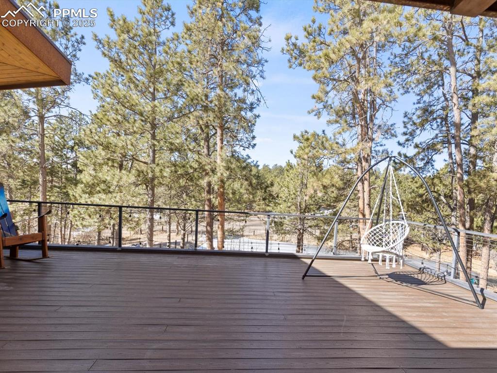 10530 Hungate Road Colorado Springs, CO 80908 - Photo 33 of 42 a view of outdoor space with deck and a garden
