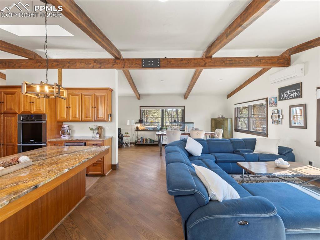 10530 Hungate Road Colorado Springs, CO 80908 - Photo 9 of 42 a living room with furniture kitchen view and a large window