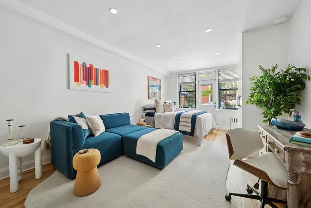 a living room with furniture and a potted plant