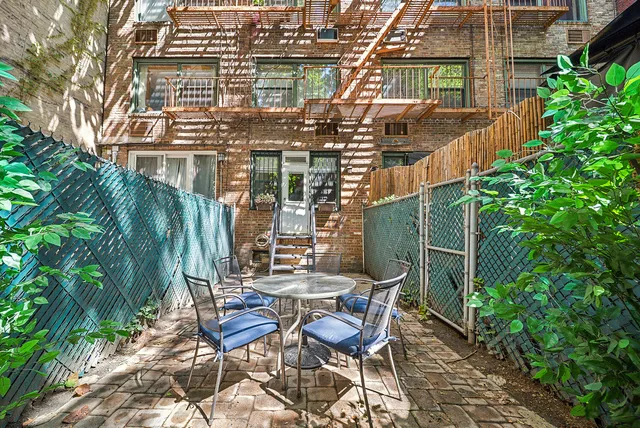 a view of table and chairs under an umbrella