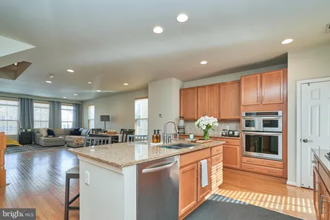 a kitchen with counter top space a sink cabinets and stainless steel appliances