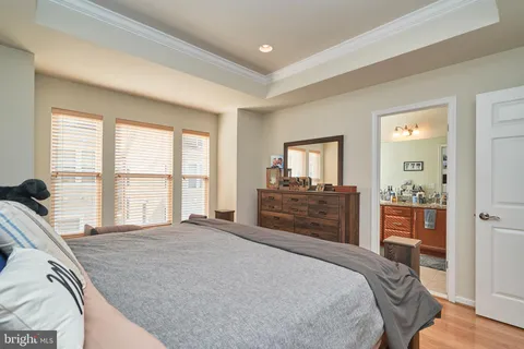 a bedroom with a large bed and a dresser