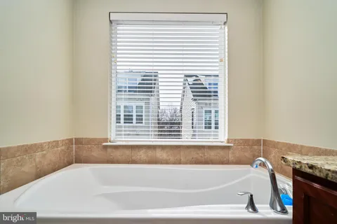 a white bath tub sitting next to a window