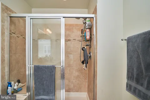 a bathroom with a glass shower door