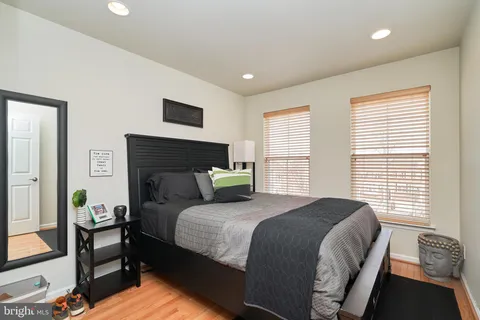 a bedroom with a bed and a night stand