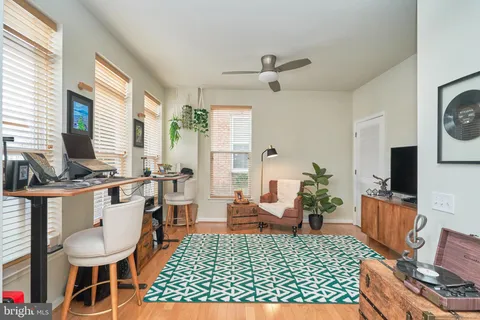 a living room with furniture a rug and a window