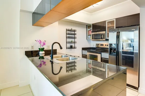 a kitchen with stainless steel appliances granite countertop a sink and cabinets