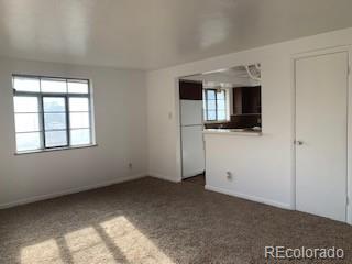 1265 Yates Street Denver, CO 80204 - Photo 11 of 17 a view of kitchen with flat screen tv and refrigerator