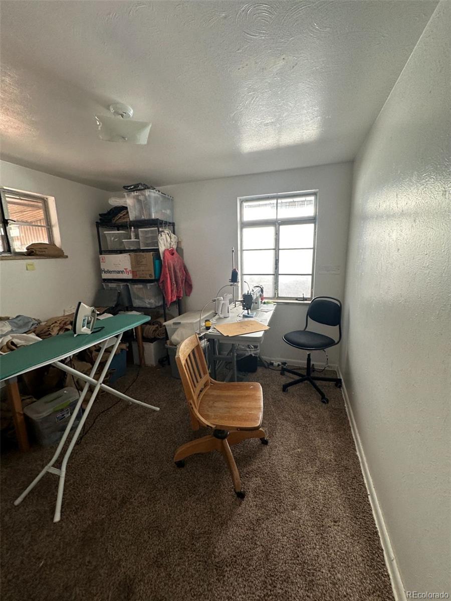 1265 Yates Street Denver, CO 80204 - Photo 12 of 17 a living room with furniture a air conditioner and a window