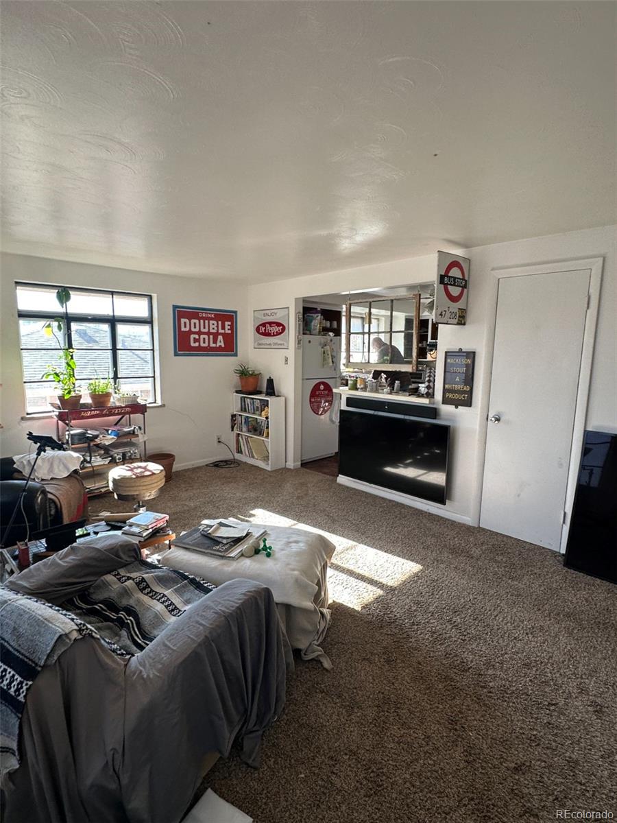 1265 Yates Street Denver, CO 80204 - Photo 2 of 17 a living room with furniture kitchen and a window