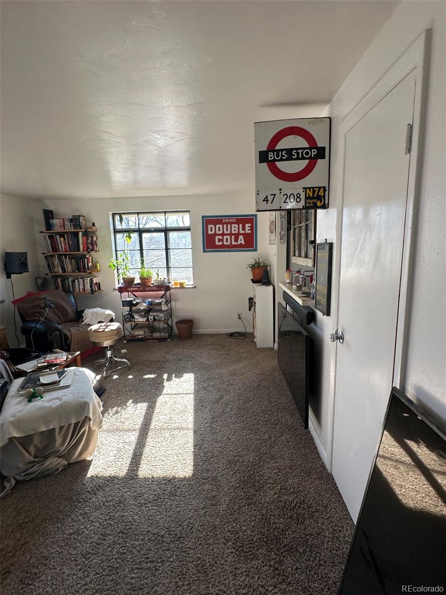 1265 Yates Street Denver, CO 80204 - Photo 4 of 17 a view of a room with furniture and a window