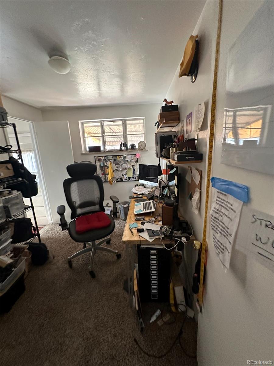 1265 Yates Street Denver, CO 80204 - Photo 5 of 17 a room with furniture a flat screen tv and a window