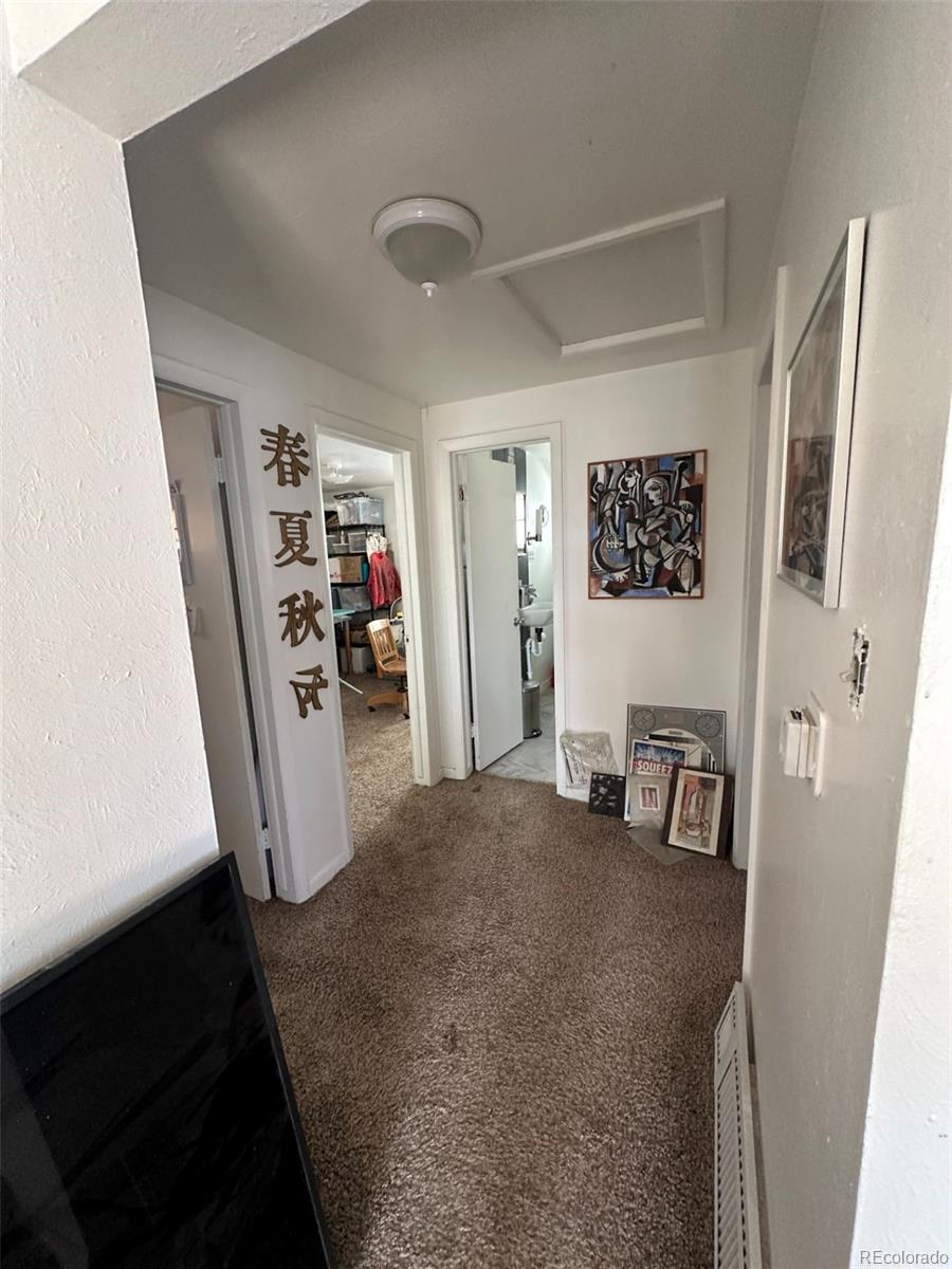 1265 Yates Street Denver, CO 80204 - Photo 8 of 17 a view of a livingroom with furniture and refrigerator