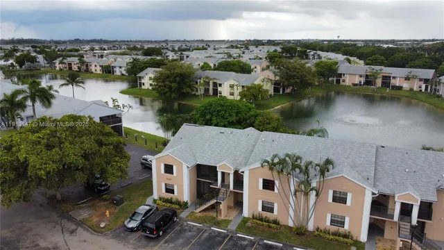 an aerial view of a house with a garden and lake view