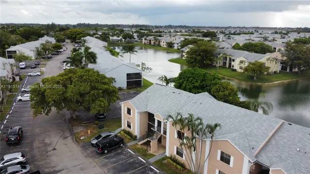 an aerial view of a house with a lake view
