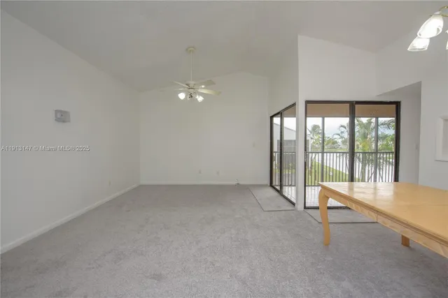 an empty room with sliding glass door and mountain view