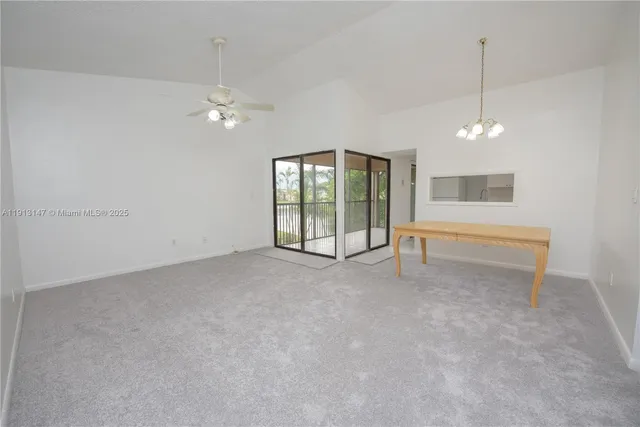 a view of a livingroom with a ceiling fan window and hardwood floor