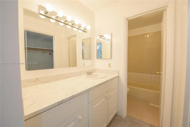 a bathroom with a sink a vanity and a mirror