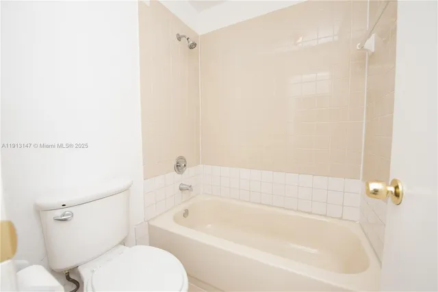 a white bath tub sitting next to a white toilet