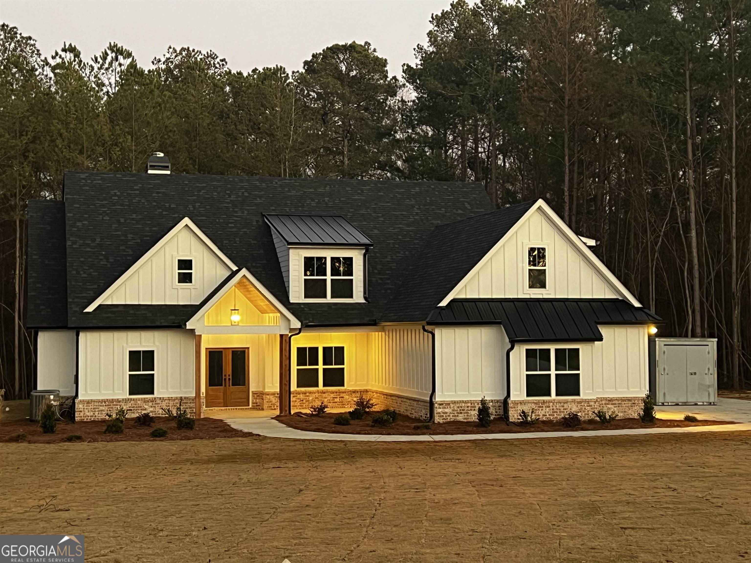 a front view of a house with a yard and balcony