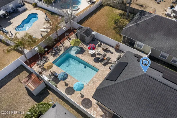 an aerial view of a house a table and chairs